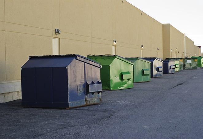 a construction worker moves construction materials near a dumpster in Belleville, MI